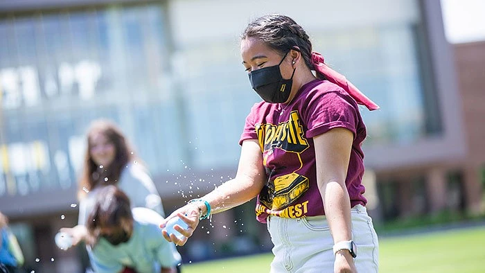Medical studies first-year student Francesca Maglalang (right) catches a water balloon — though it burst — during the SOLERA water balloon toss