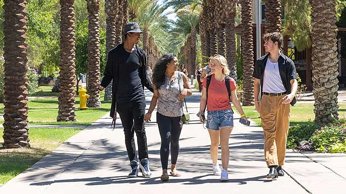 Top photo: (From left) Qamar Outley, Neha Satish, Olivia Radack and Masen Barnes — all first-year students from Arizona — take a stroll on Palm Walk on Monday. 