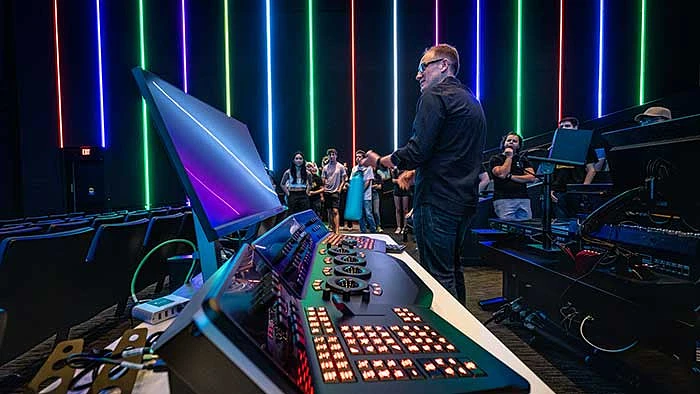 Assistant Professor Philip Klucsarits gives his Cinematography I students a short tour of the 280-seat screening auditorium with its state-of-the-art video editing and audio editing stations on Aug. 23 at the new Media and Immersive eXperience Center at the Mesa City Center