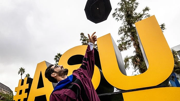Man throwing graduation hat