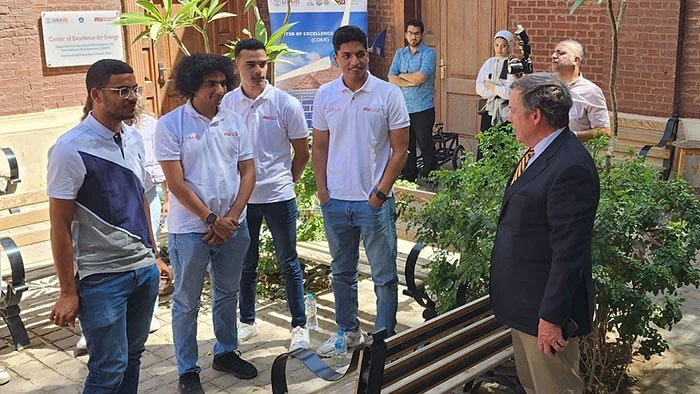 President Michael Crow talking to some young men