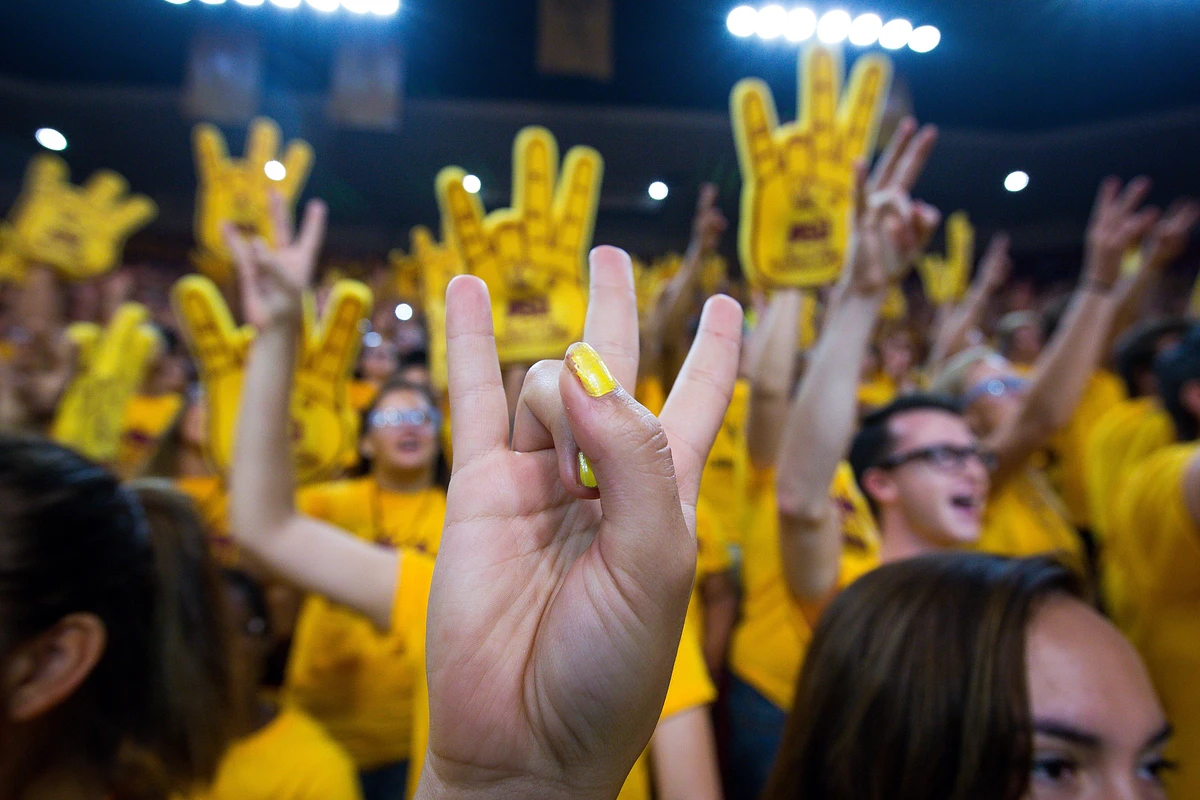 Closeup of ASU student welcome event shows pitchforks and foam fingers in the air