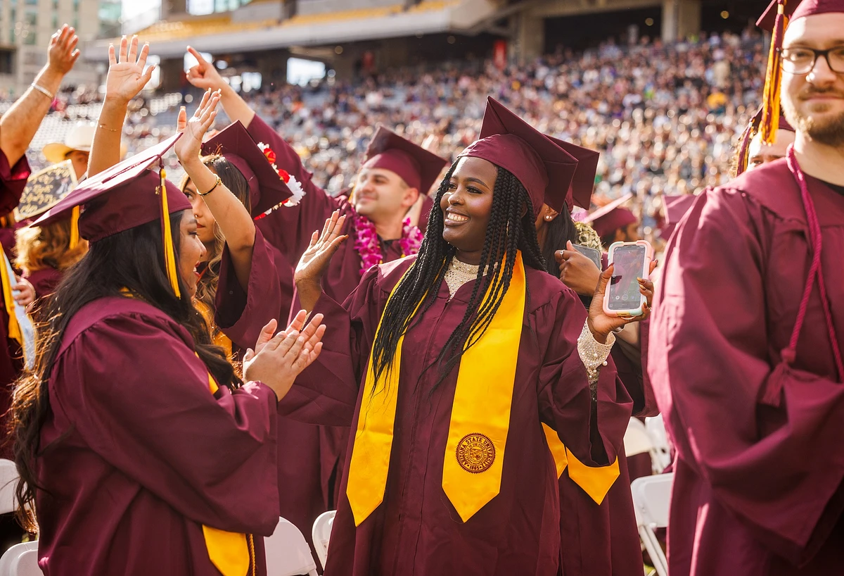 Several ASU graduates celebrate at the ceremony