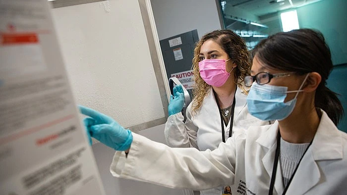 Women in medical gear and masks