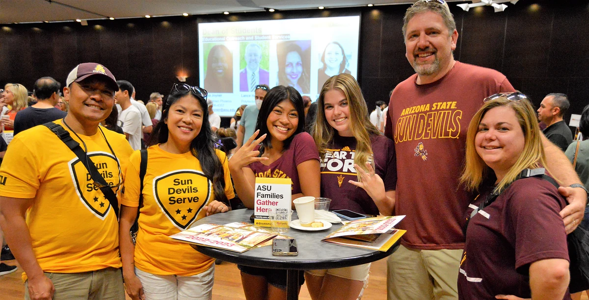 Two ASU families and their Sun Devils pose for a photo during Family Welcome