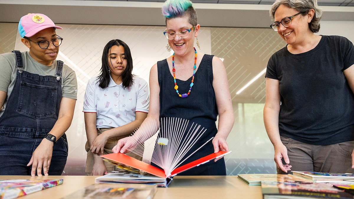From left: Student workers Victoria Silva and Kathy Nazario, ASU Library Conservator Suzy Morgan and Shari Laster, head of Open Collections Curation and Access at ASU Library, handle books from the Eugene D. Valentine Collection.