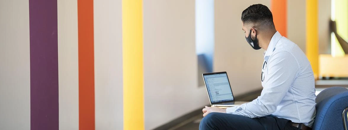 Student at computer w/facemask