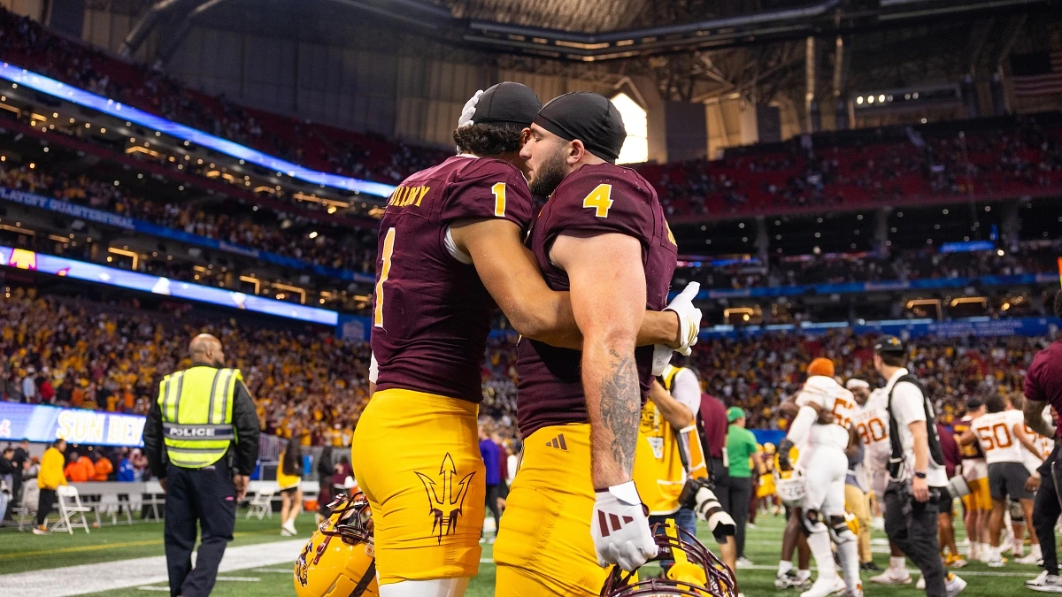 ASU senior running back Cam Skattebo (right) and redshirt senior wide receiver Xavier Guillory embrace after losing the Chick-fil-A Peach Bowl in double overtime against the University of Texas at Austin at Mercedes-Benz Stadium in Atlanta on Jan. 1