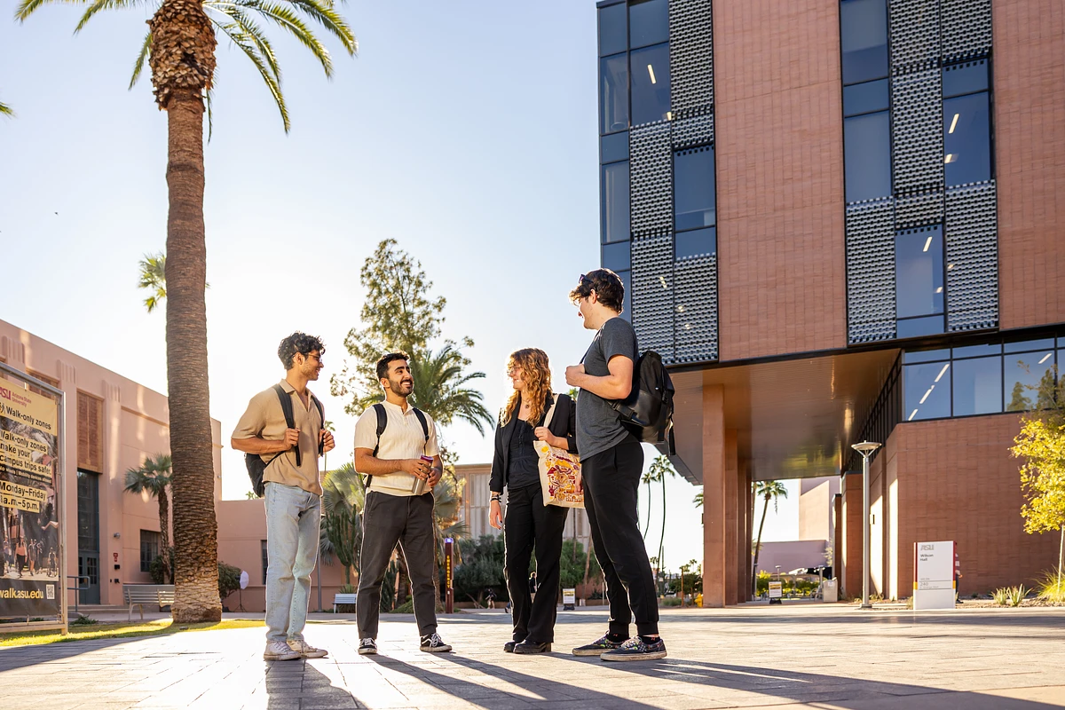Group of students talking together on the ASU  Tempe campus on a sunny day