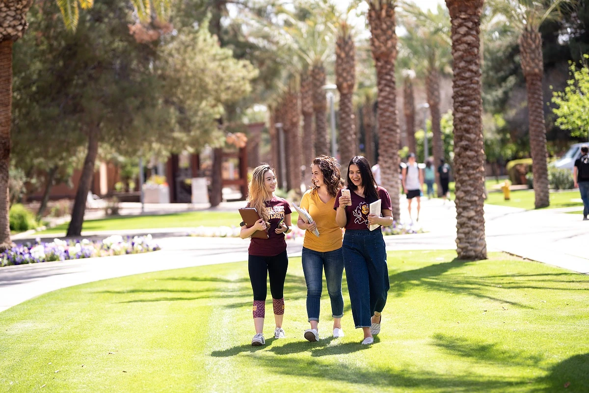 Three ASU students walk across campus to class